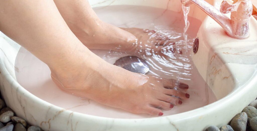 04 Washing-female-feet-in-a-marble-sink-spa-feet-water-flowing-from-tap
